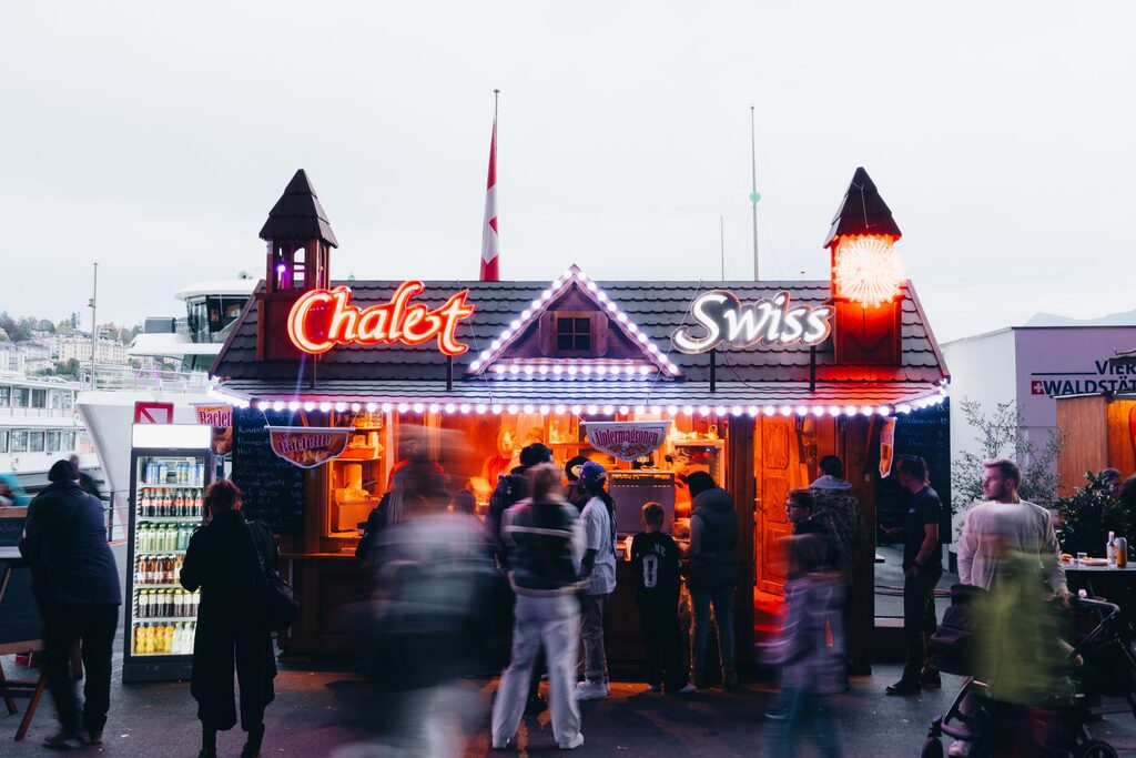 Swiss chalet street food stand with festive evening atmosphere