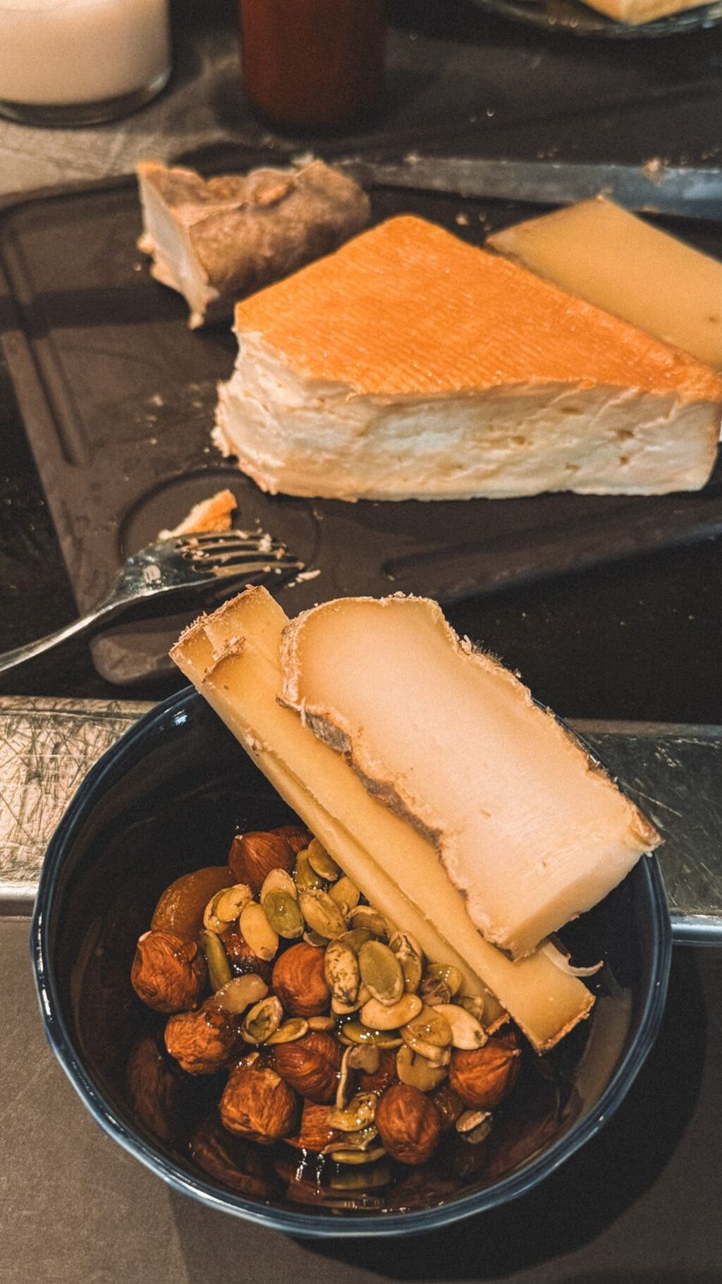 Gourmet French cheese selection with olives and nuts — raclette traditions
