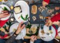 Raclette cheese melting traditions from around the world on a rustic board