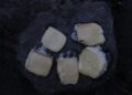 melting raclette cheese scraped from open flame — raclette without a machine