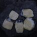 melting raclette cheese scraped from open flame — raclette without a machine