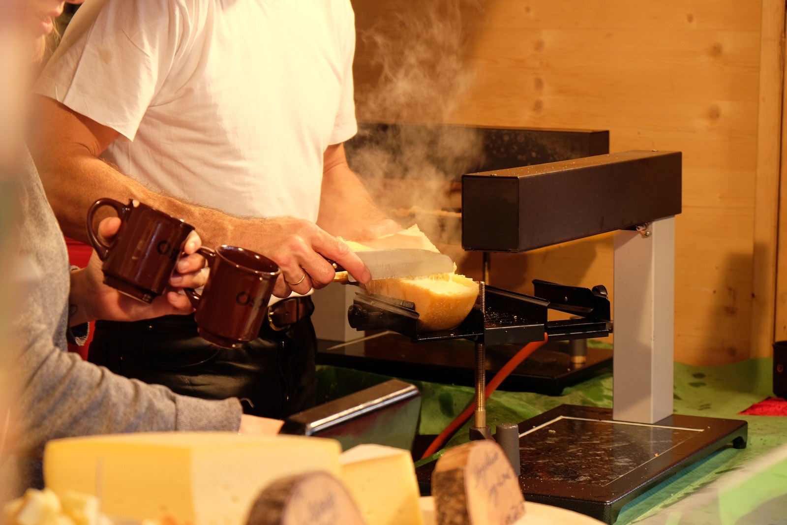 raclette grill with melted cheese and colourful vegetables for vegetarian recipe